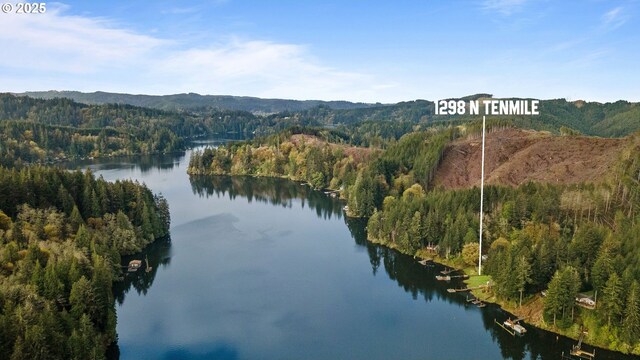 1298 N Tenmile, Lakeside, OR 97449 - property view of water featuring a wooded view and a mountain view
