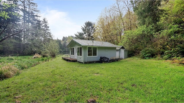 1298 N Tenmile, Lakeside, OR 97449 - rear view of house featuring metal roof and a lawn
