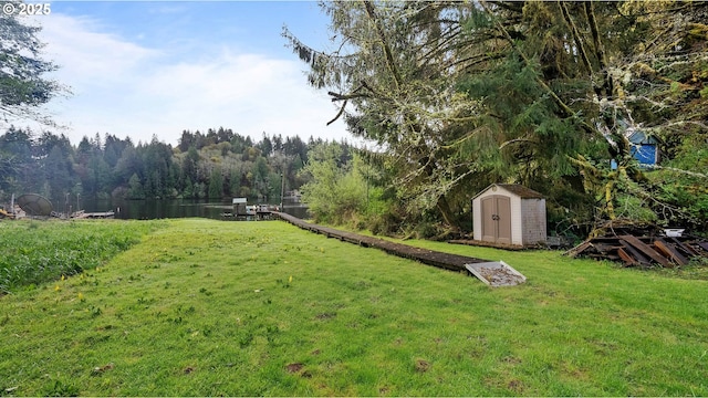 1298 N Tenmile, Lakeside, OR 97449 - view of yard featuring a forest view, an outbuilding, and a storage unit