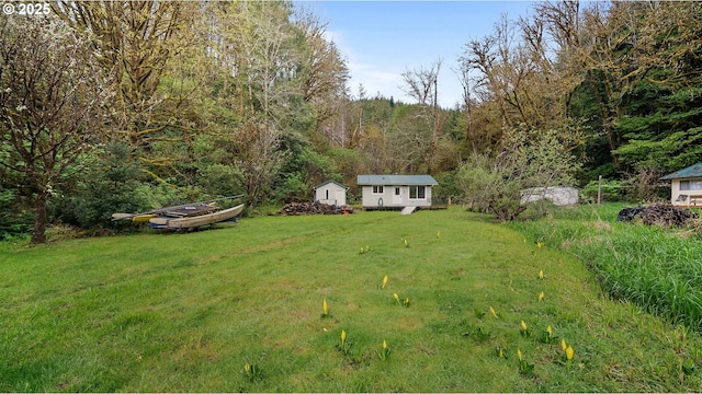 1298 N Tenmile, Lakeside, OR 97449 - view of yard with a view of trees, an outdoor structure, and a storage unit