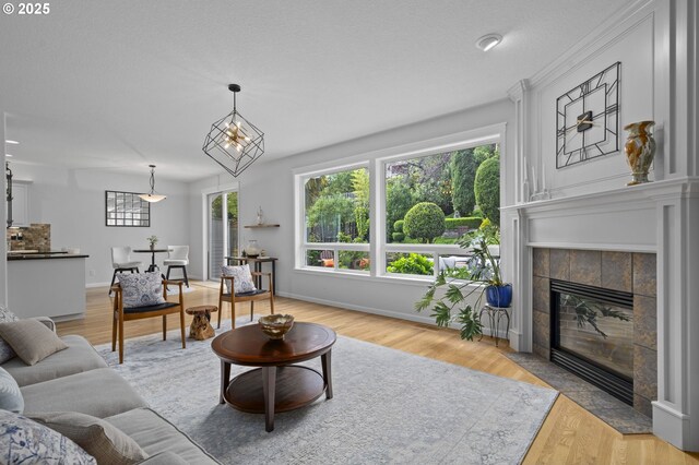 living area featuring wood finished floors and a tile fireplace