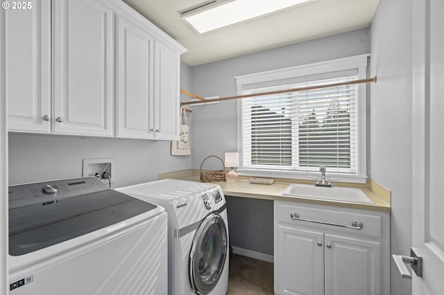 laundry area with a sink, cabinet space, and washing machine and clothes dryer