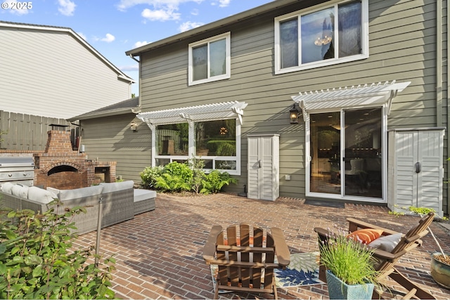 rear view of house featuring an outdoor living space with a fireplace, a pergola, and a patio