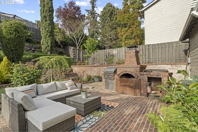 view of patio with an outdoor living space, fence, and grilling area