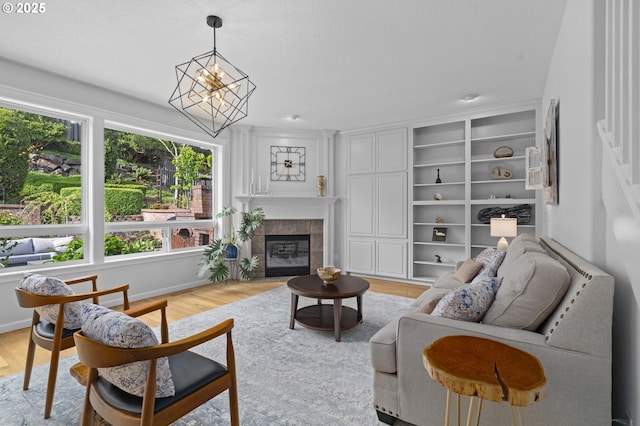living room featuring a fireplace, a wealth of natural light, and light wood-type flooring