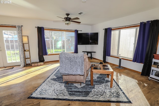 dining area featuring visible vents, baseboards, wood finished floors, and a ceiling fan