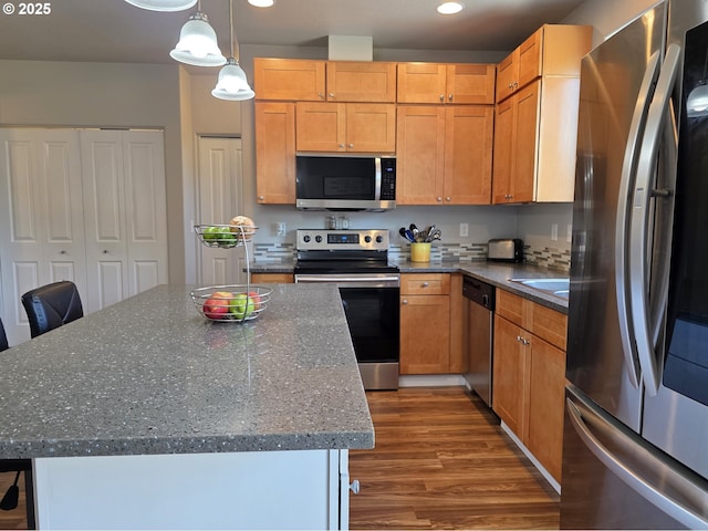 755 Nebraska St, Eugene, OR 97402 - kitchen with stainless steel appliances, wood finished floors, recessed lighting, pendant lighting, and a kitchen island