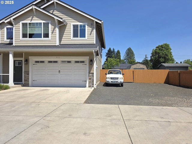 755 Nebraska St, Eugene, OR 97402 - view of front of home with driveway, stone siding, and a garage