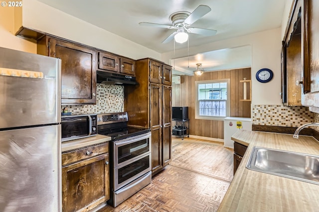kitchen featuring a sink, light countertops, stainless steel appliances, and dark brown cabinets
