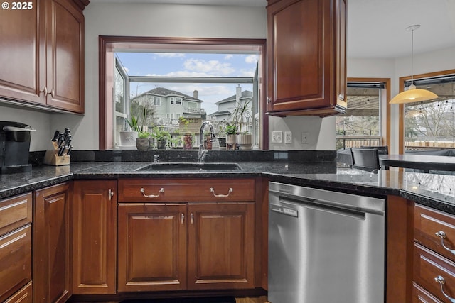 kitchen featuring pendant lighting, sink, and stainless steel dishwasher