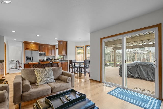 living room with sink and light hardwood / wood-style flooring