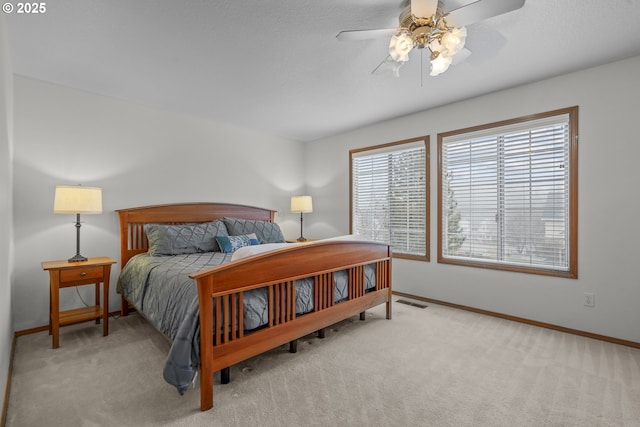 bedroom featuring light colored carpet and ceiling fan