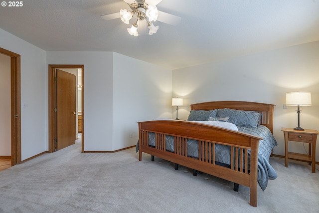 bedroom with light colored carpet, a textured ceiling, and ceiling fan