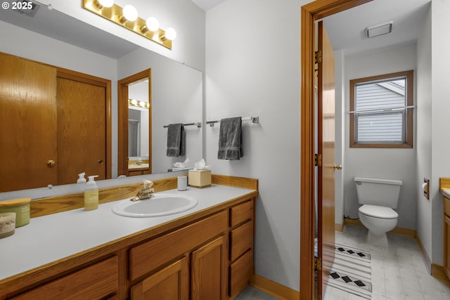 bathroom with vanity and toilet