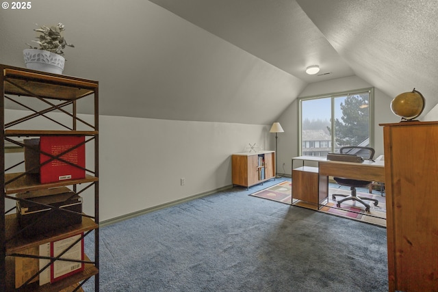 carpeted office space with vaulted ceiling and a textured ceiling