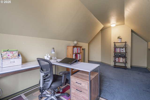 office with dark colored carpet and vaulted ceiling