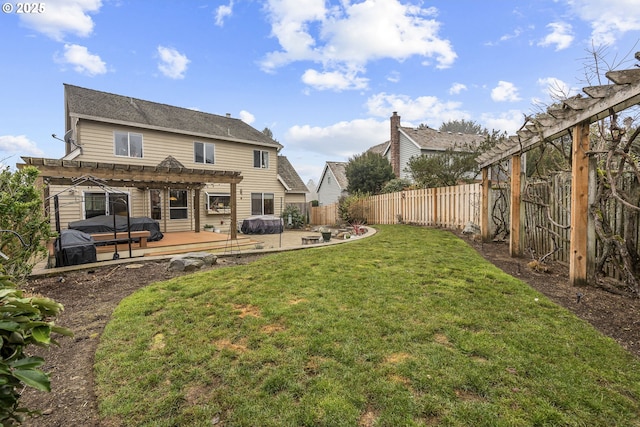 back of property featuring a pergola, a deck, and a lawn