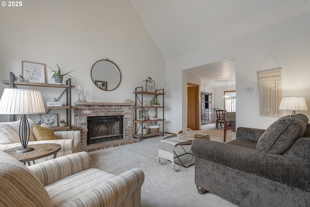 living room featuring light colored carpet, a fireplace, and high vaulted ceiling