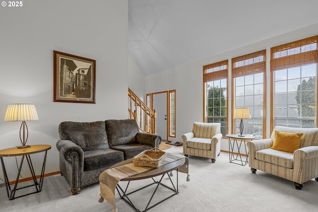 living room featuring light colored carpet and high vaulted ceiling