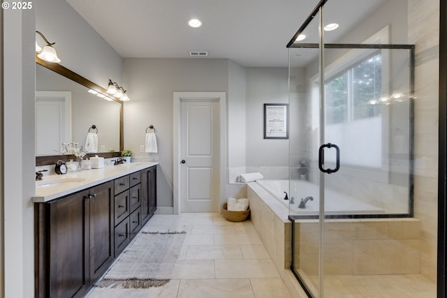 865 SW Trillium Ln, Portland, OR 97219 - bathroom with double vanity, a garden tub, a shower stall, and recessed lighting