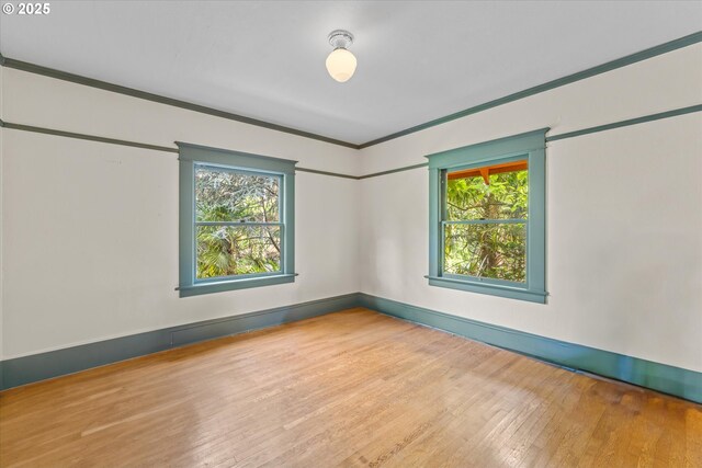 2516 NE Clackamas St, Portland, OR 97232 - empty room featuring healthy amount of natural light, wood finished floors, and ornamental molding