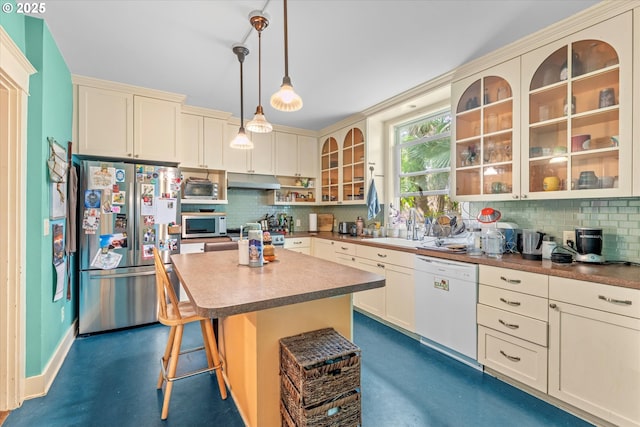 2516 NE Clackamas St, Portland, OR 97232 - kitchen featuring freestanding refrigerator, dishwasher, decorative backsplash, and cream cabinets