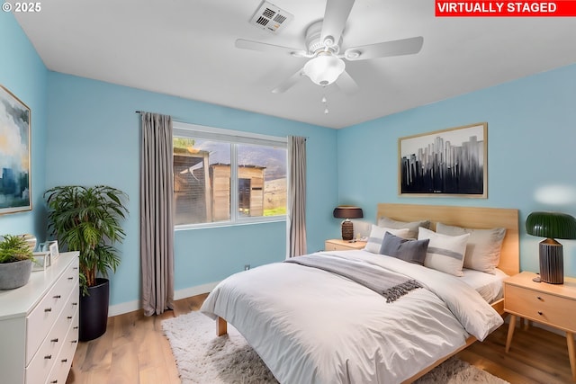 bedroom featuring ceiling fan and light hardwood / wood-style flooring