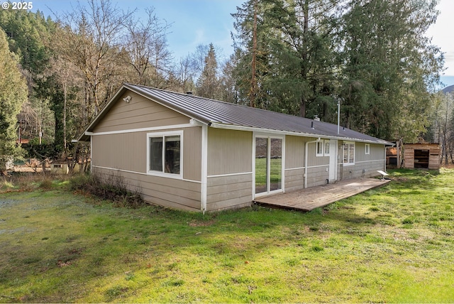 back of house with a lawn