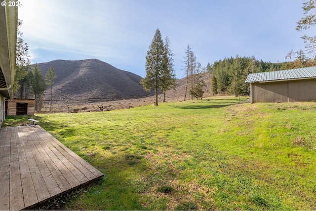 view of yard featuring a deck with mountain view