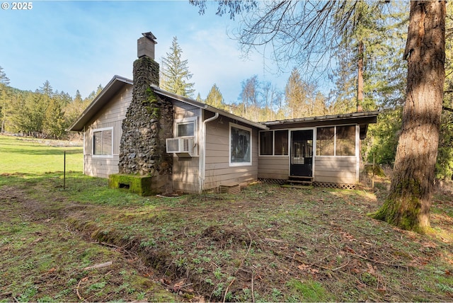 rear view of property featuring a sunroom