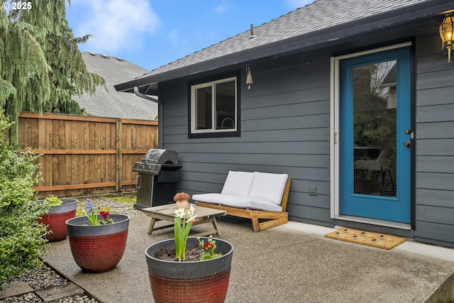 view of patio with area for grilling and fence