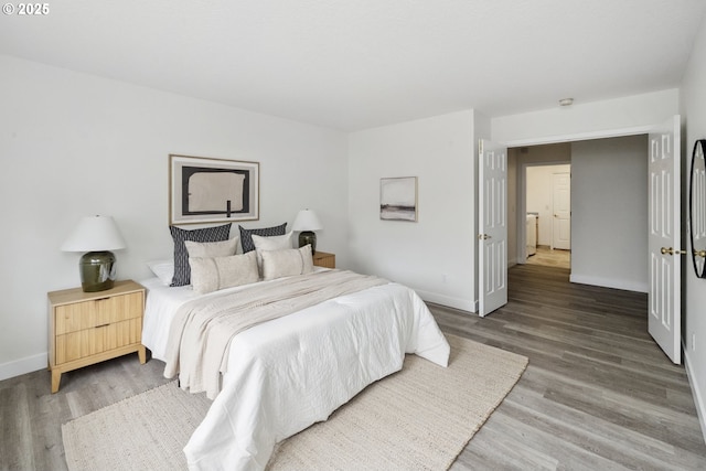 bedroom featuring light wood-style flooring and baseboards