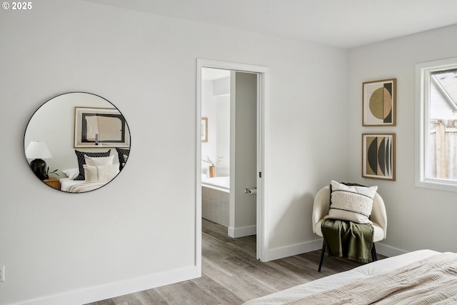 bedroom with light wood-type flooring and baseboards