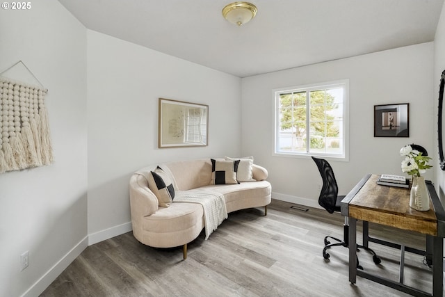 office space featuring visible vents, baseboards, and wood finished floors