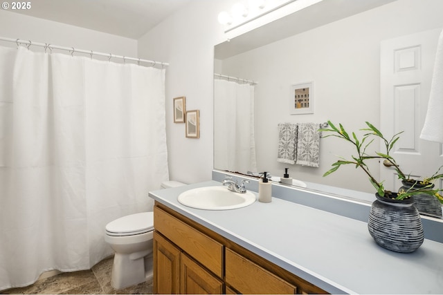 bathroom with toilet and vanity