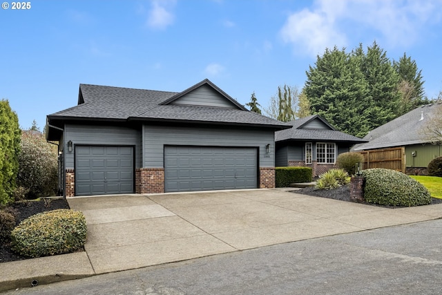 ranch-style home with concrete driveway, an attached garage, brick siding, and a shingled roof