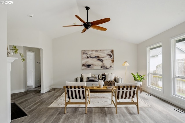 dining space featuring light wood finished floors, visible vents, lofted ceiling, and a ceiling fan