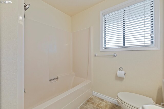 full bath with baseboards and toilet