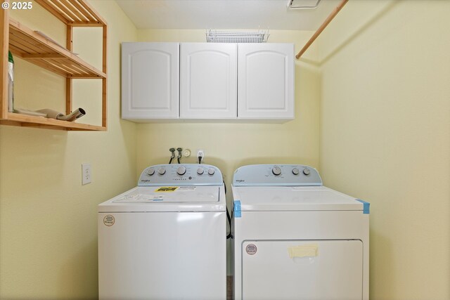 washroom with cabinet space and washing machine and dryer