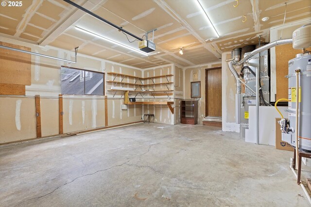 garage featuring water heater, heating unit, a garage door opener, and electric panel