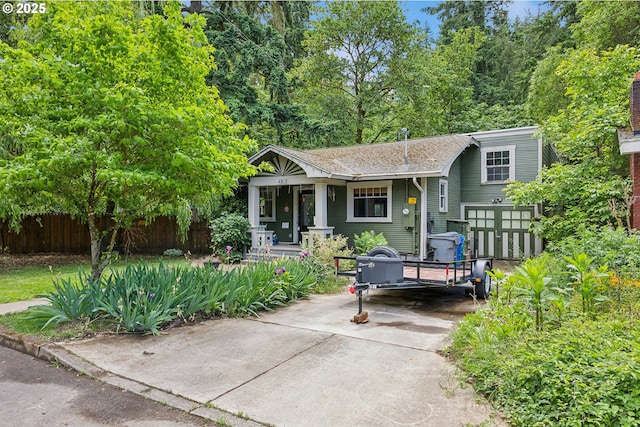4315 NE 90th Ave, Portland, OR 97220 - view of front facade featuring covered porch, a shingled roof, and driveway