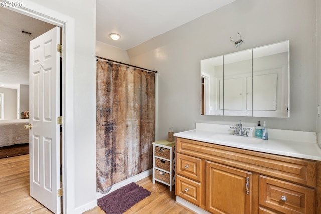 4315 NE 90th Ave, Portland, OR 97220 - ensuite bathroom featuring wood finished floors, vanity, and a shower with curtain