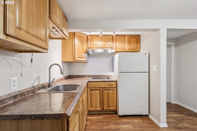 4315 NE 90th Ave, Portland, OR 97220 - kitchen featuring freestanding refrigerator, a sink, under cabinet range hood, dark wood-style flooring, and cooktop