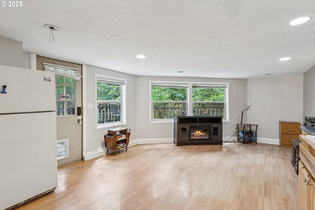 4315 NE 90th Ave, Portland, OR 97220 - living room featuring a fireplace, light wood-style floors, plenty of natural light, baseboards, and recessed lighting