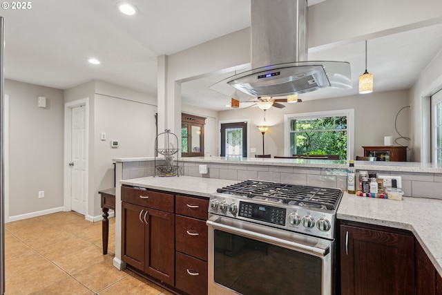 4315 NE 90th Ave, Portland, OR 97220 - kitchen with stainless steel range with gas cooktop, island range hood, recessed lighting, light tile patterned floors, and dark brown cabinetry