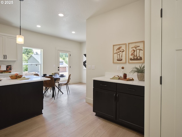117 Witherbee Rd, Kelso, WA 98626 - kitchen featuring dark cabinets, light countertops, decorative light fixtures, light wood finished floors, and recessed lighting