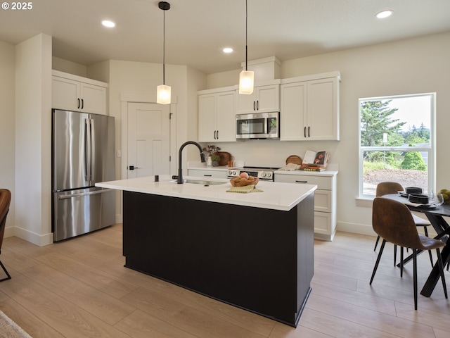 117 Witherbee Rd, Kelso, WA 98626 - kitchen with appliances with stainless steel finishes, a sink, light wood-style floors, light countertops, and baseboards