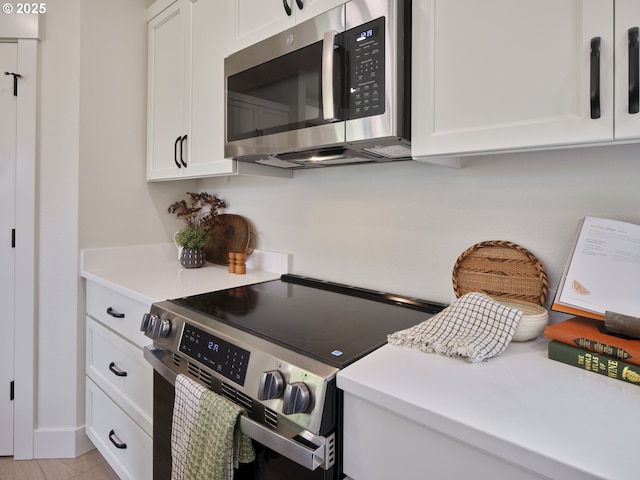 117 Witherbee Rd, Kelso, WA 98626 - kitchen featuring stainless steel appliances, white cabinetry, and light countertops