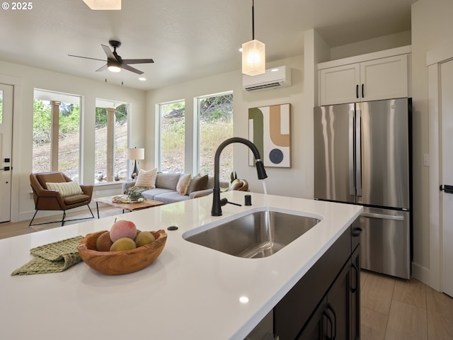 117 Witherbee Rd, Kelso, WA 98626 - kitchen with freestanding refrigerator, a sink, an AC wall unit, open floor plan, and light countertops