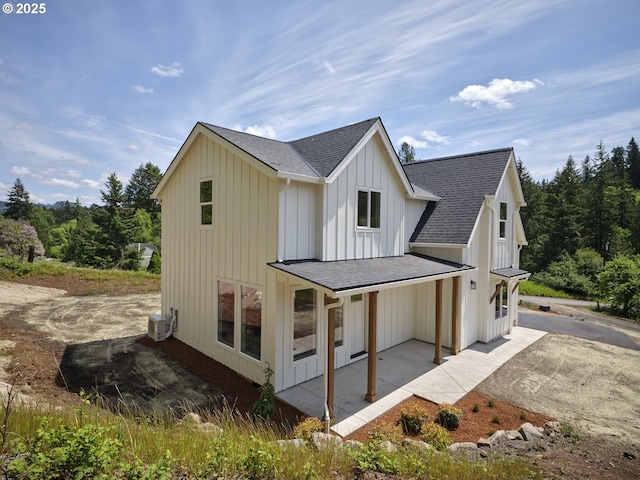 117 Witherbee Rd, Kelso, WA 98626 - view of side of home with a shingled roof, board and batten siding, and a patio area